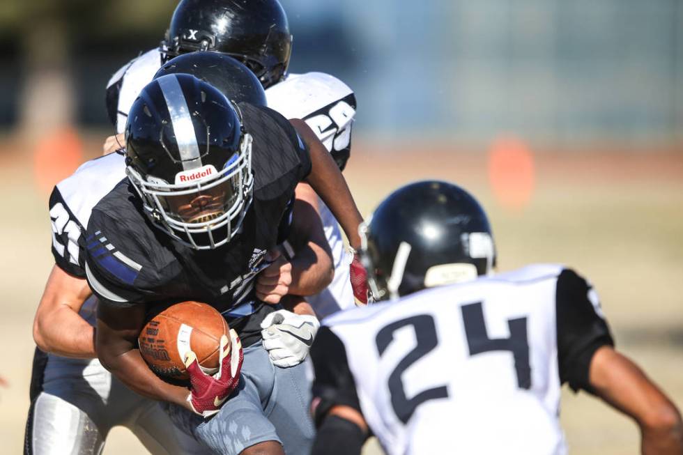 Desert Pines’ Ezekiel Washington (21) runs the ball against Spring Creek during the se ...