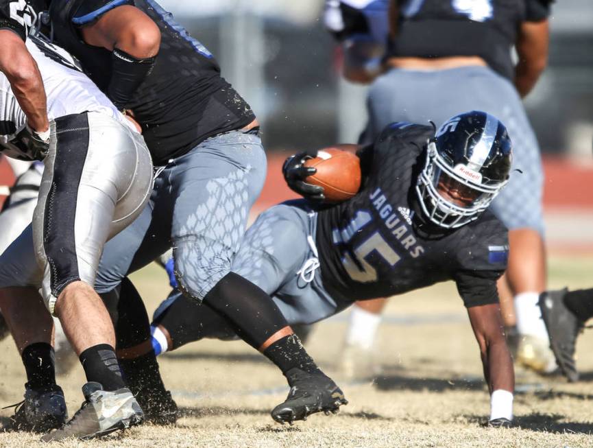 Desert Pines’ Michael Lofton (15), right, touches the ground during a run against Spri ...