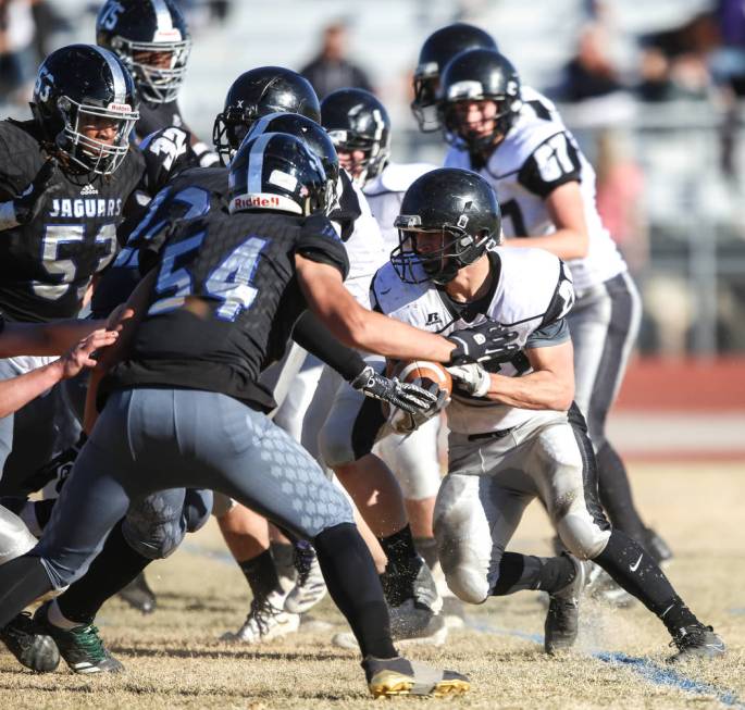 Spring Creek’s Jason Painter (22), right, runs the ball against Desert Pines during th ...