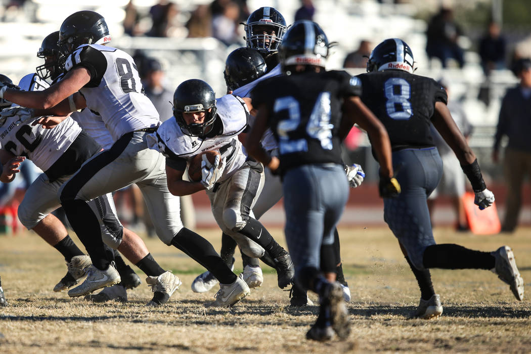 Spring Creek’s Jason Painter (22) runs the ball against Desert Pines during the third ...