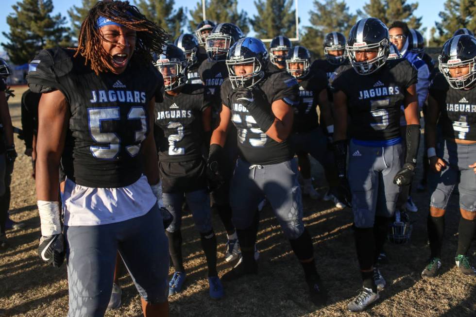 Desert Pines’ Lorenzo Sheldon Brown (53), left, celebrates with teammates after defeat ...