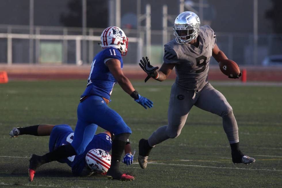 Liberty player Jake Dedeaux (11) takes after Bishop Gorman player Brevin Jordan (9) as he ru ...