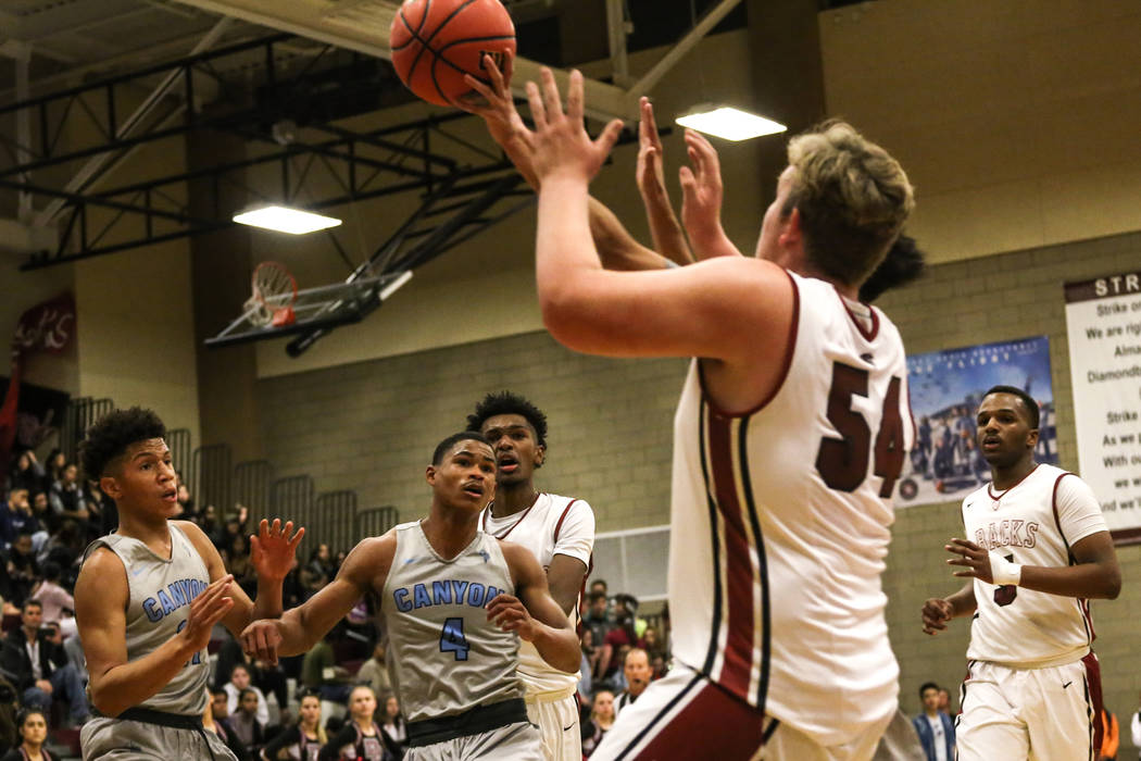 Canyon SpringsՠKevin Legardy (4), second from right, watches as his teammates chase af ...