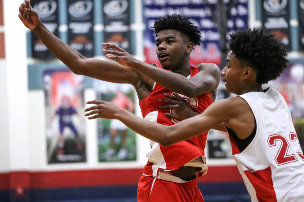 Coronado freshman Jaden Hardy, left, is guarded by teammate Issac Spears, right, during a ba ...