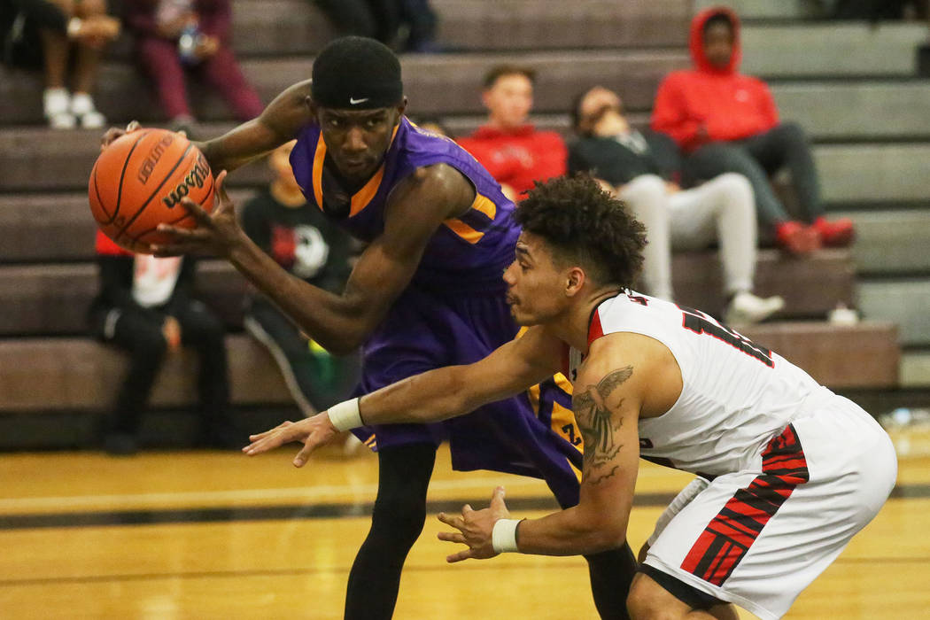 Las Vegas player Donovan Joyner (12) guards Durango player LeAndre McIntyre (12) as he looks ...