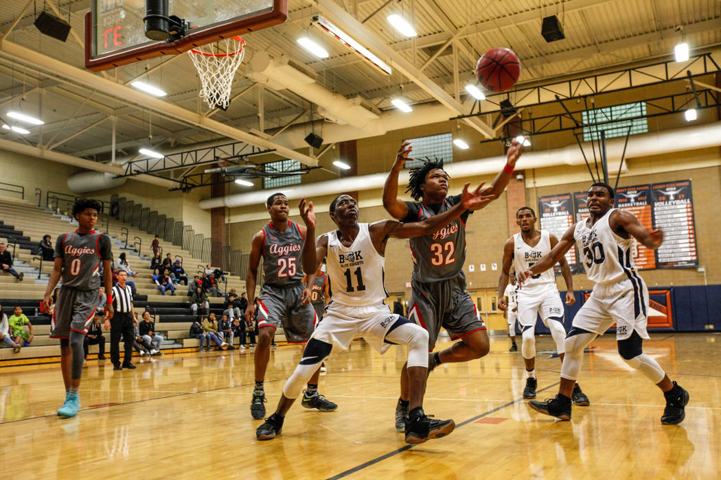 Democracy Prep’s Jared Holmes (11) and Arbor View’s Jeremiah Wade (32) reach for ...