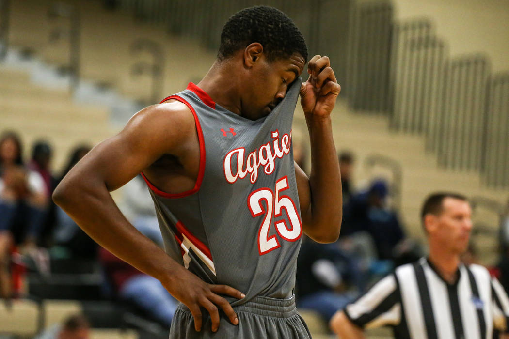 Arbor View’s Jarrod Burks (25) wipes off sweat between free-throws against Democracy P ...