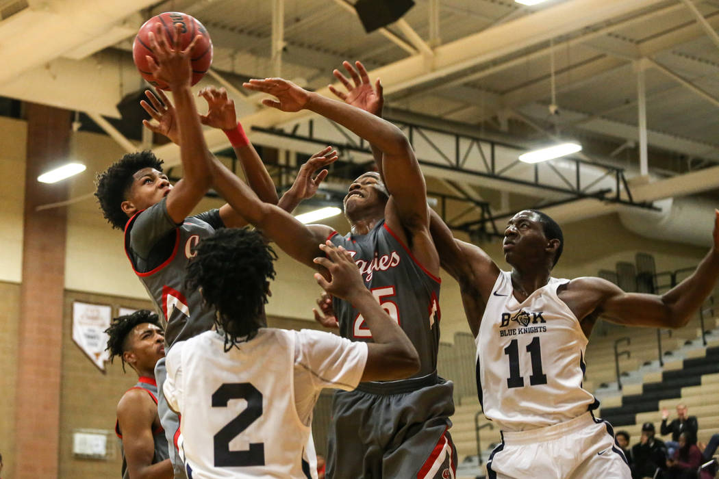 Arbor View’s Donovan Yap (0), top left, receives a rebound as his teammate Jarrod Burk ...