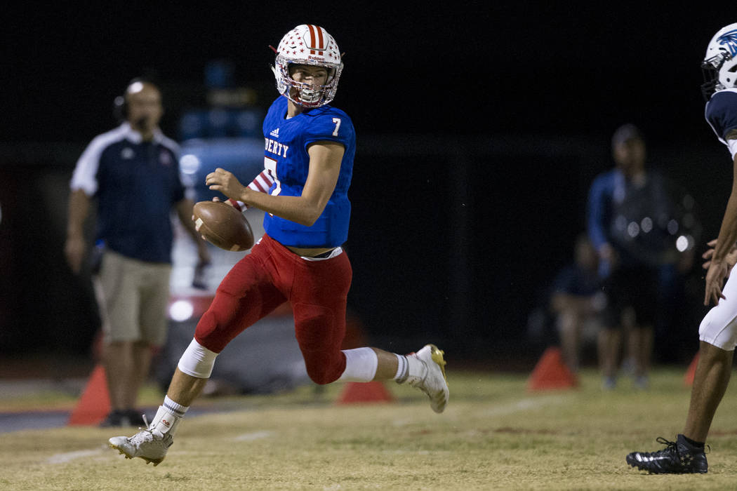 Liberty’s Kenyon Oblad (7) runs the ball against Foothill in their football game at Li ...