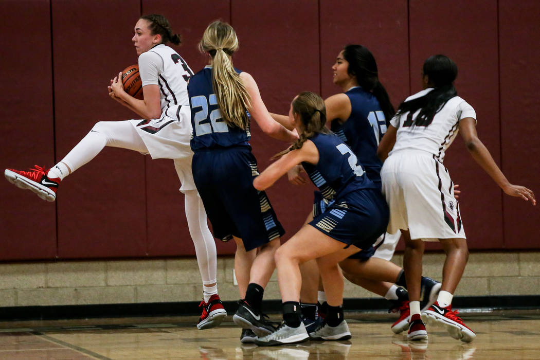 Desert Oasis’ Sierra Mich’l (30), left, catches a rebound during the second quar ...