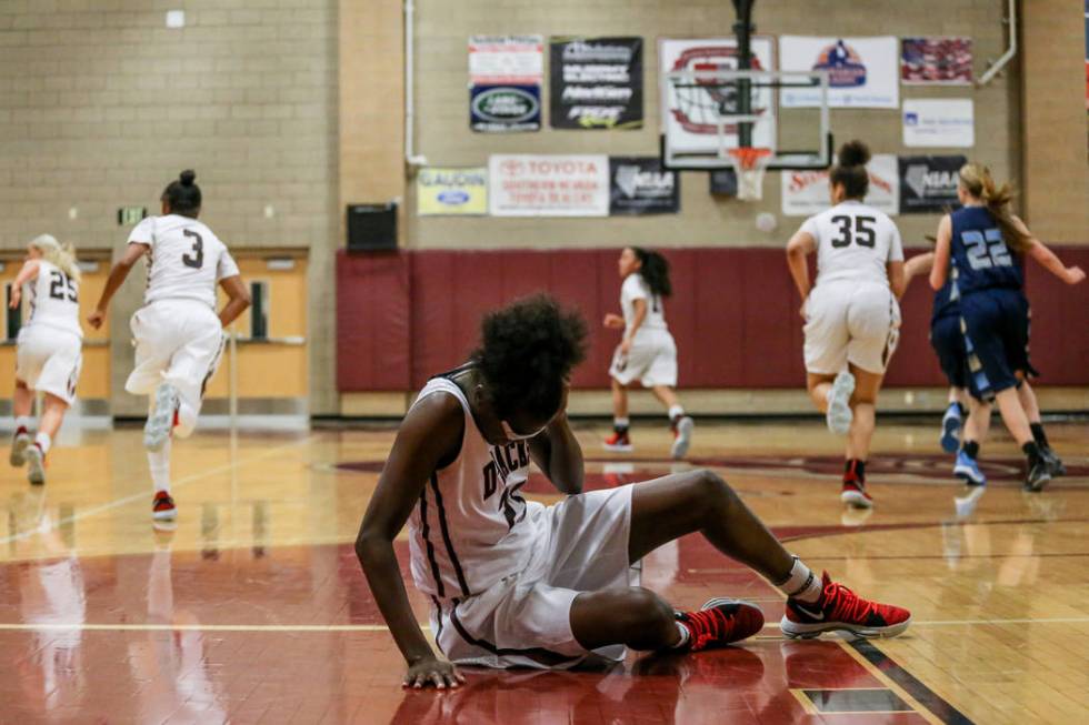 Desert Oasis’ Desi-rae Young (23) rubs her head after hitting the ground during the fo ...