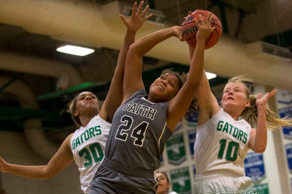 Faith Lutheran’s Kayla Proctor (24) is blocked by Green Valley’s Samara Miller ( ...