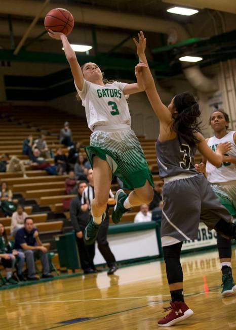 Green Valley senior Temerity Bauer, left, shoots over Faith Lutheran’s Madison Bocobo ...