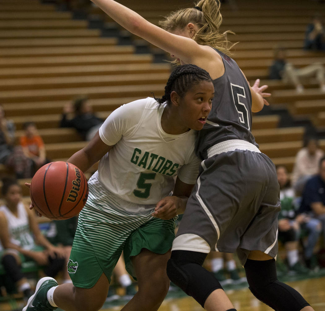 Green Valley junior Shelby Clark, left, drives the ball against Faith Lutheran’s Kenda ...