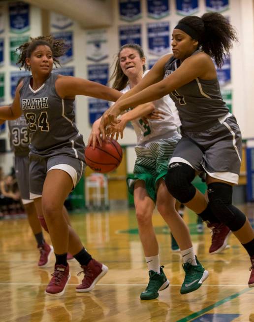 Faith Lutheran’s Kayla Proctor (24) and Casey Proctor (4) rip the ball away from Green ...