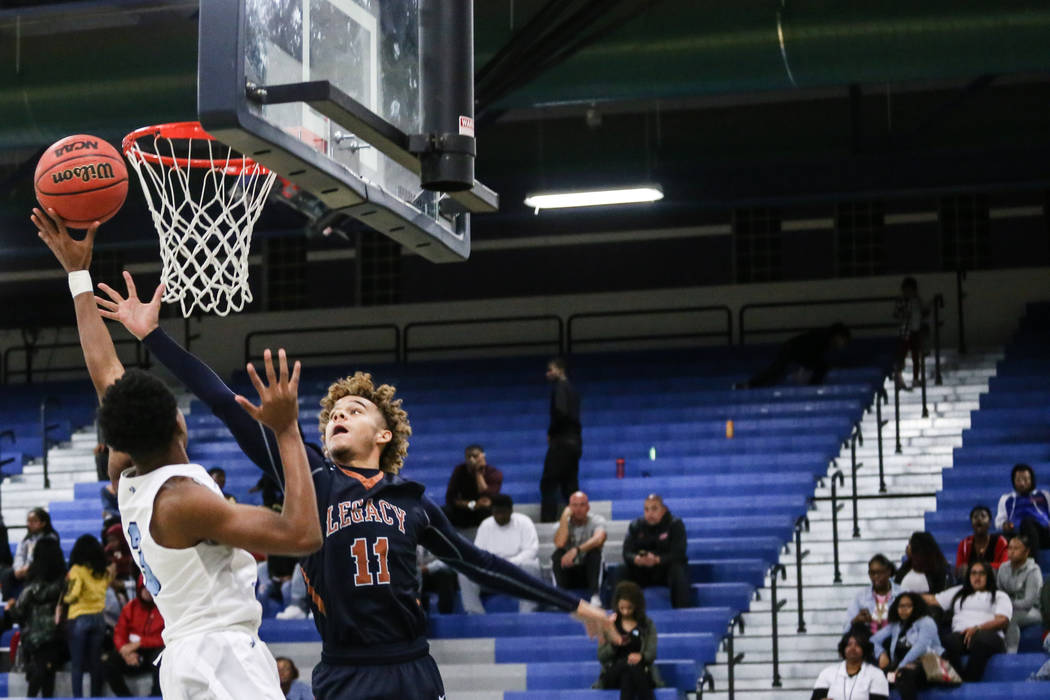 Canyon SpringsՠJorden Williams (3), left, is blocked by Legacyճ Tyrell Nolen (11 ...