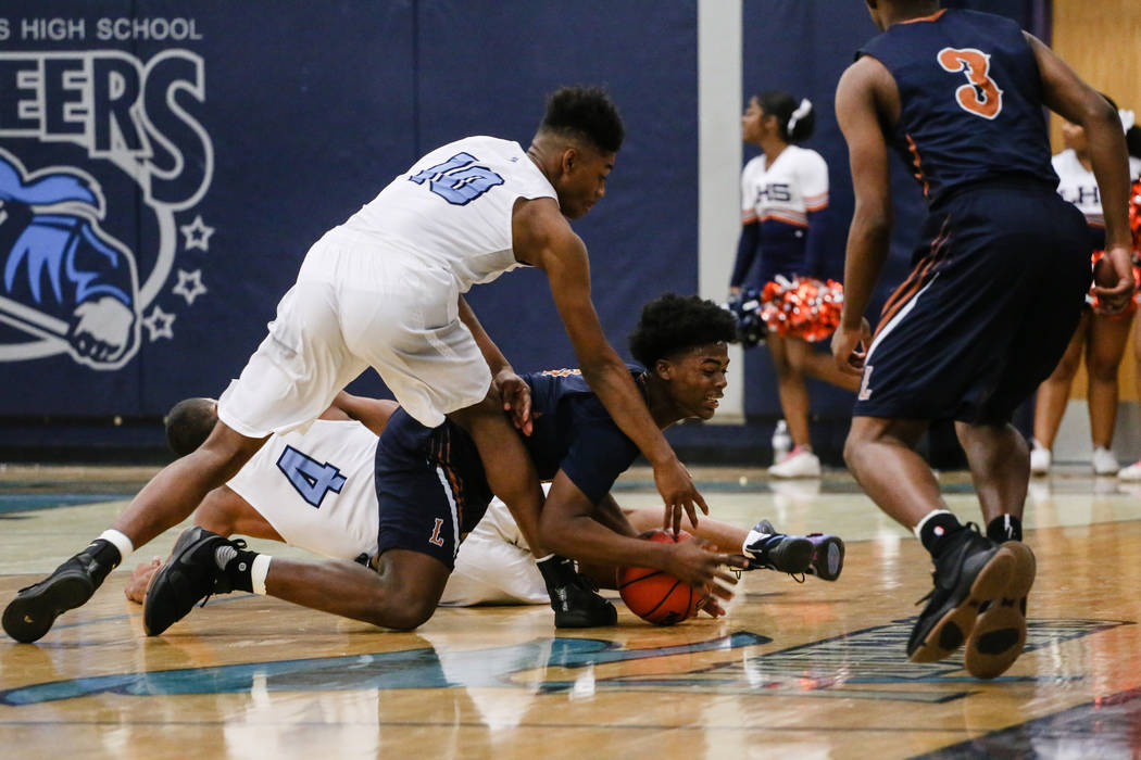 Legacyճ Cristian Pitts (3), center, jumps for the ball as Canyon SpringsՠChristo ...