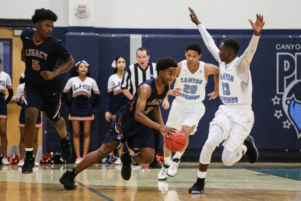 Legacyճ Chris White (5), left, watches as teammate Cristian Pitts (3), second from lef ...