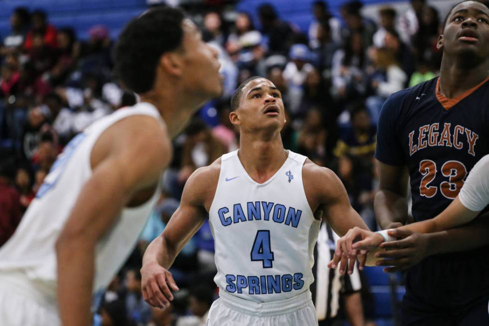 Canyon SpringsՠKevin Legardy (4), center, eyes the ball following a free-throw during ...