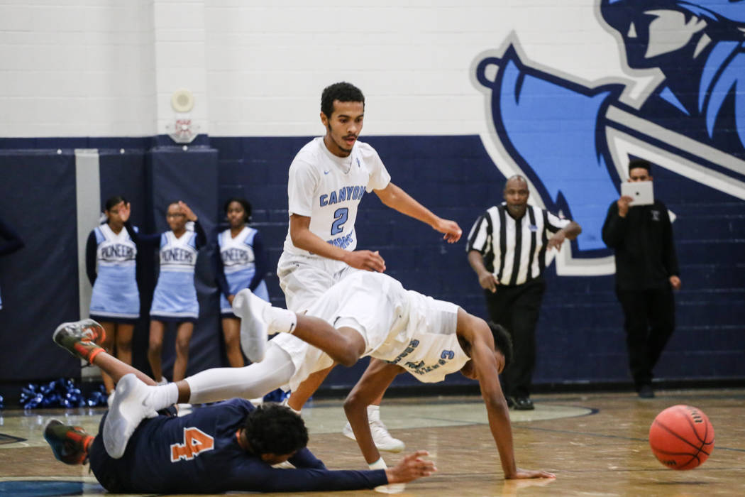 Legacyճ Jayvon Lewis (4), left, and Canyon SpringsՠJorden Williams (3), center, ...