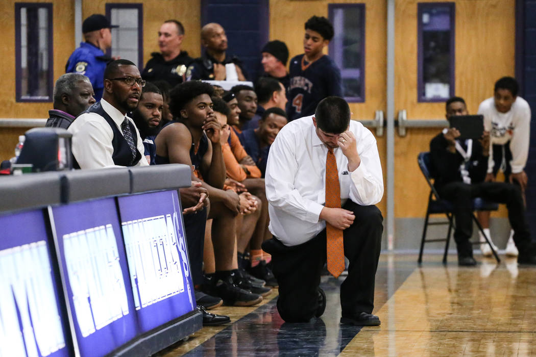 Legacy head coach Jack Tarango III kneels as he rubs his head following a Canyon Springs fre ...