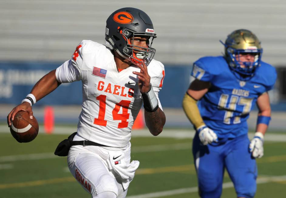 Bishop Gorman’s quarterback Dorian Thompson-Robinson scrambles under pressure from Ree ...