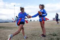 Coronado quarterback Caitlin Shannon, a 17-year-old junior, right, hands the ball off to tea ...