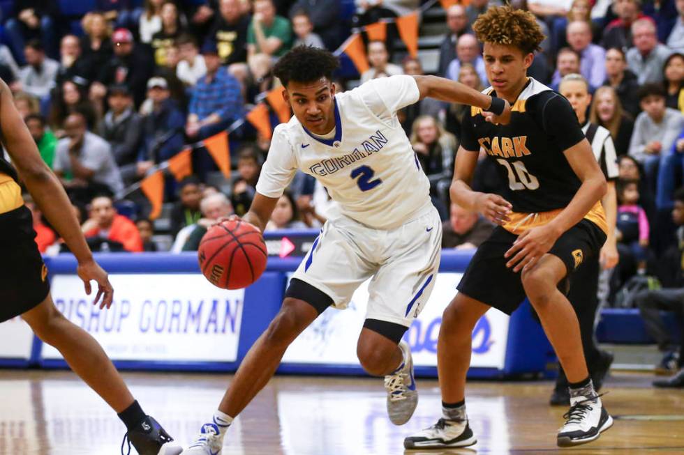 Bishop Gorman Jamal Bey (2) drives to the basket past Clark forward Jalen Hill (20) during a ...