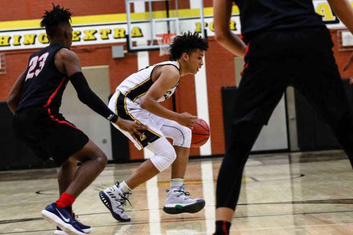 Liberty’s Davion Ware (23) guards Clark Chargers’ Jalen Hill (21) during the sec ...