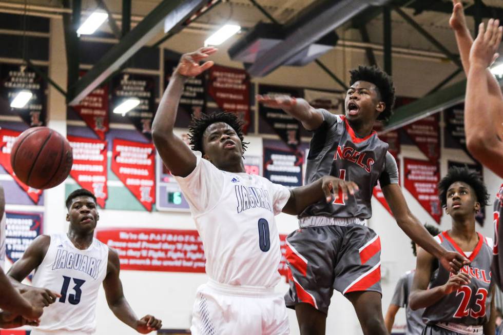 Desert Pines’ Hasani Pullens (0) is blocked by Denver East’ Kaelan Potts (1) dur ...