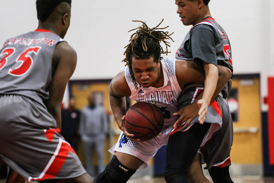 Denver East’s Akanbi Akigbogun (35) and Denver East’s Patrick Steed (5) guard De ...