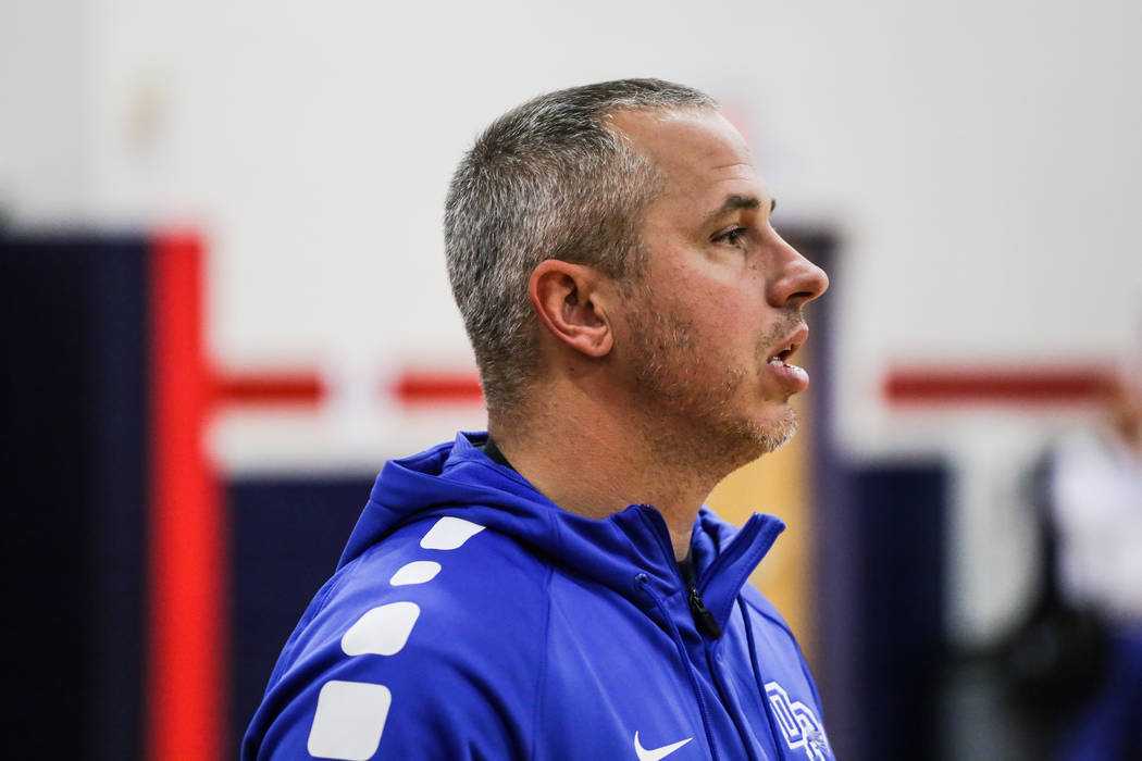 Desert Pines head coach Michael Uzan watches during the second half of a basketball game aga ...