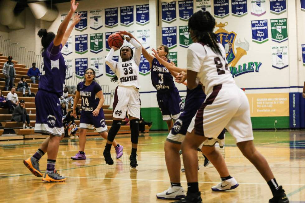 Cimarron-Memorial’s Amoura Whitney (33) shoots the ball Spanish Springs’ Jada To ...