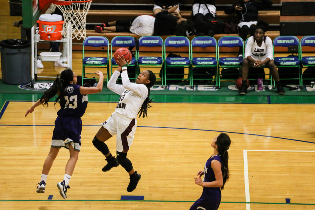 Cimarron-Memorial’s Amoura Whitney (33) shoots the ball as she is guarded by Spanish S ...