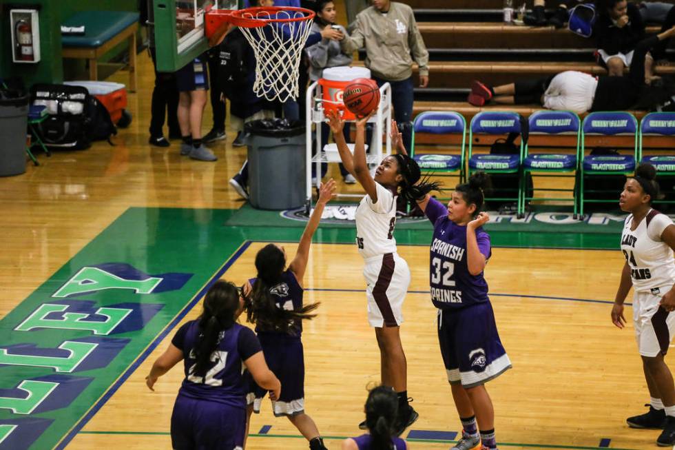 Cimarron-Memorial’s Yesenia Wesley-Nash (24) shoots the ball as she is guarded by Span ...