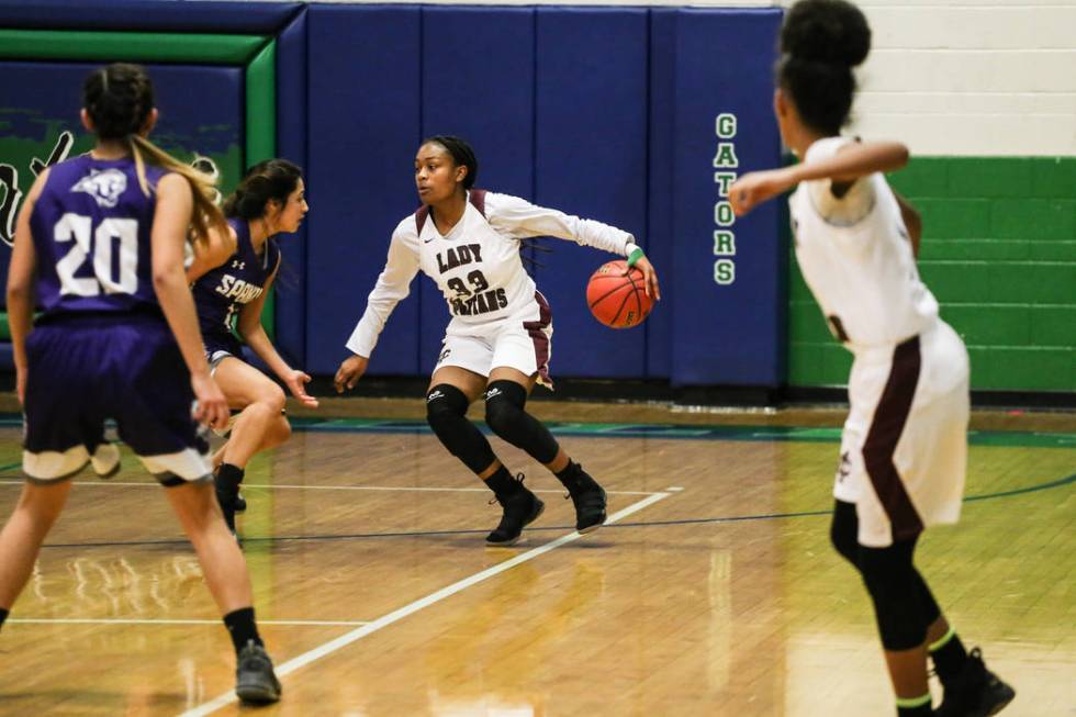 Cimarron-Memorial’s Amoura Whitney (33) dribbles the ball as she is guarded by Spanish ...