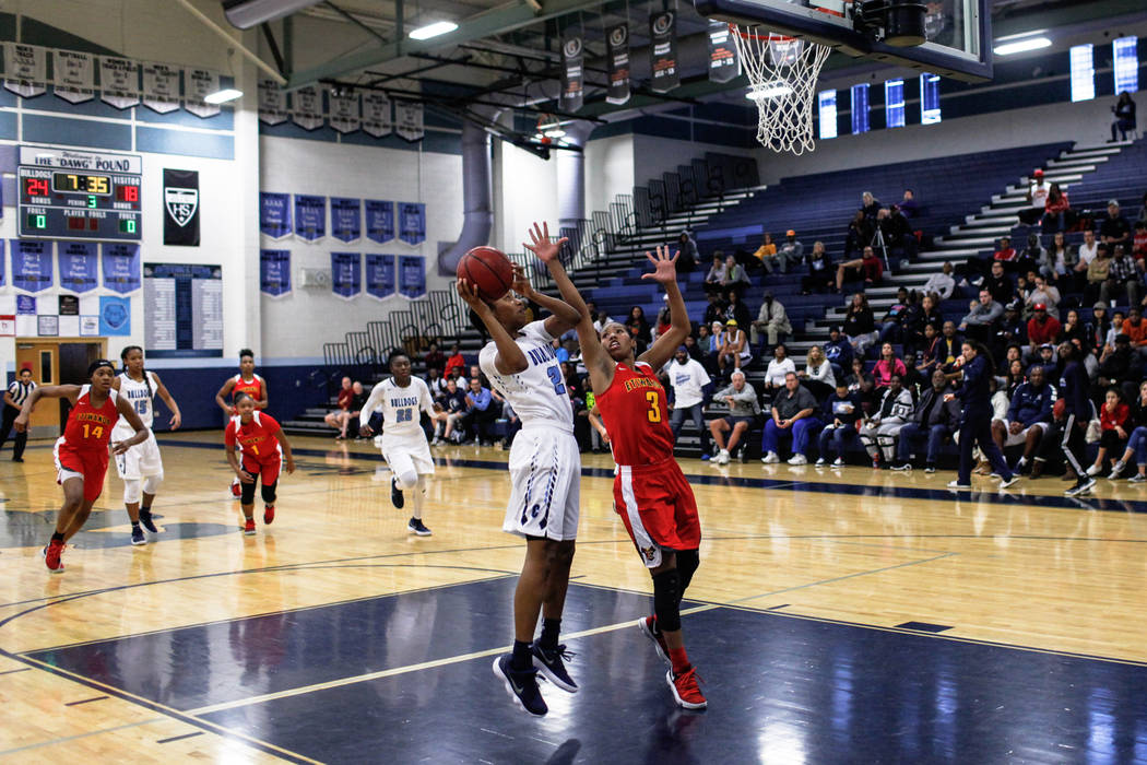 Centennial’s Melanie Isbell (2) shoots the ball as she is guarded by Etiwanda’s ...