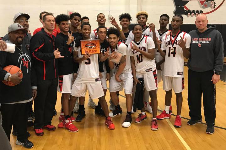 Las Vegas players and coaches pose with the Las Vegas Prep Championship trophy after beating ...