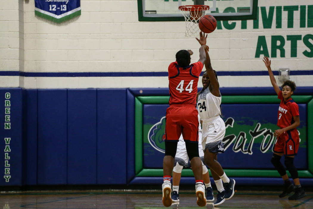 Liberty’s Dre’una Edwards (44) shoots the ball as she is guarded by Spring Vall ...