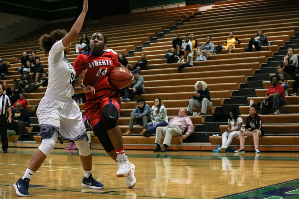 Spring Valley’s Kayla Harris (11) guards Liberty’s Dre’una Edwards (44) ...