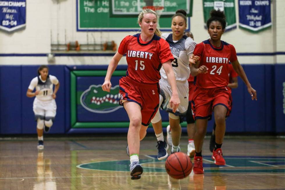 Liberty’s London Pavlica (15) dribbles the ball past Spring Valley’s Alexus Qua ...