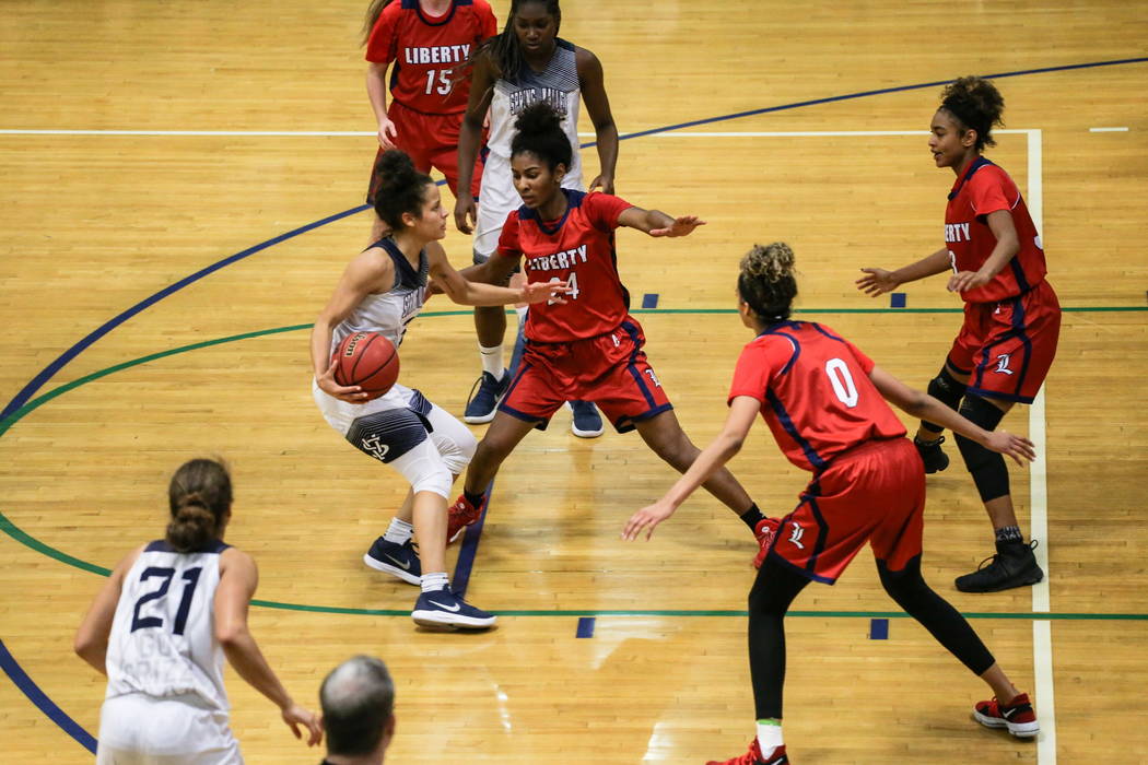 Spring Valley’s Essence Booker (3) dribbles the ball as she is guarded by Liberty&#82 ...