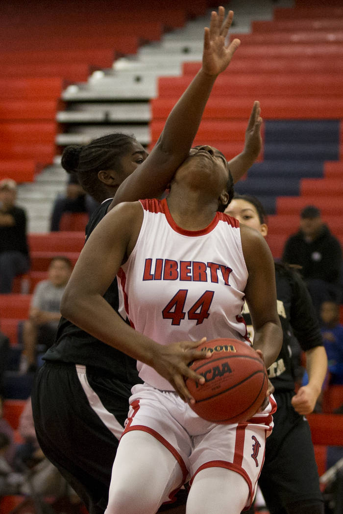 Liberty’s Dre’una Edwards (44) is pressured under the basket against Bonita Vist ...