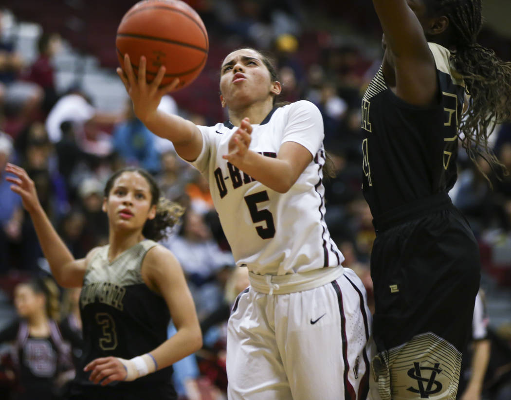 Desert Oasis’ Eliyjah Pricebrooks (5) looks to shoot past Spring Valley’s Jalynn ...