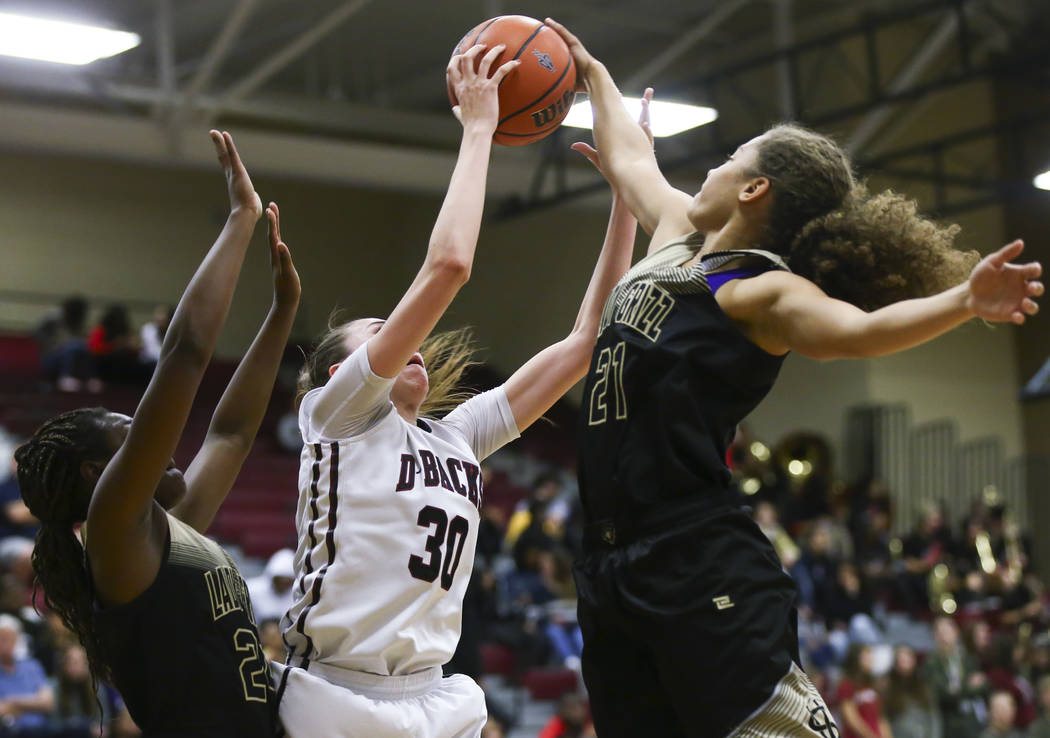 Spring Valley’s Ella Zanders (21) blocks a shot from Desert Oasis’ Sierra Mich&# ...