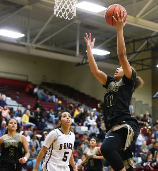 Spring Valley’s Kayla Harris (11) goes to the basket over Desert Oasis’ Eliyjah ...