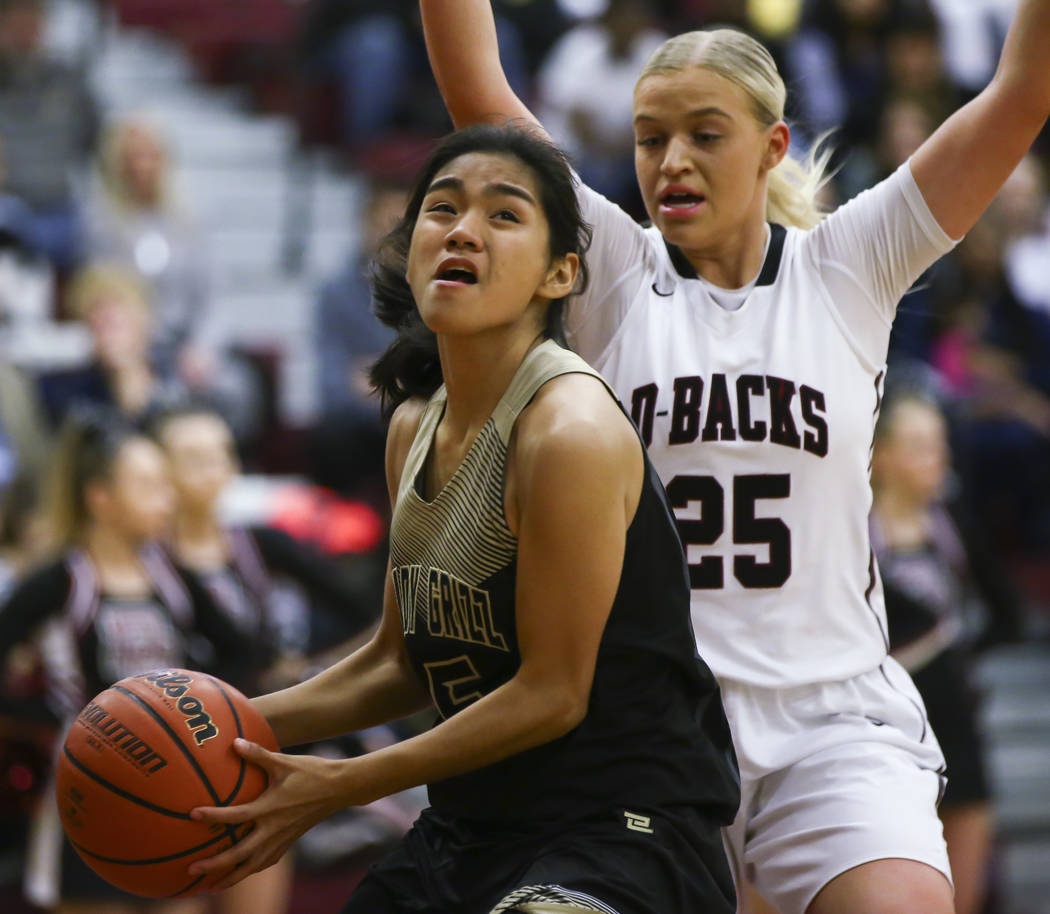 Spring Valley’s Chelsea Camara (5) looks to shoot as Desert Oasis’ Melissa Simmo ...