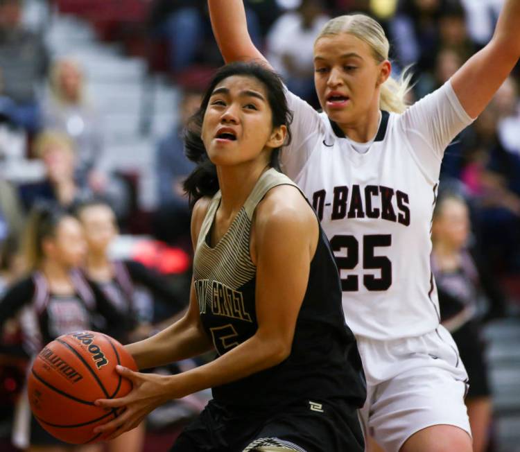 Spring Valley’s Chelsea Camara (5) looks to shoot as Desert Oasis’ Melissa Simmo ...