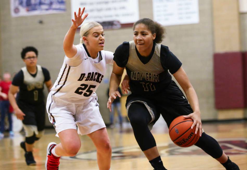 Spring Valley’s Kayla Harris (11) drives against Desert Oasis’ Melissa Simmons ( ...