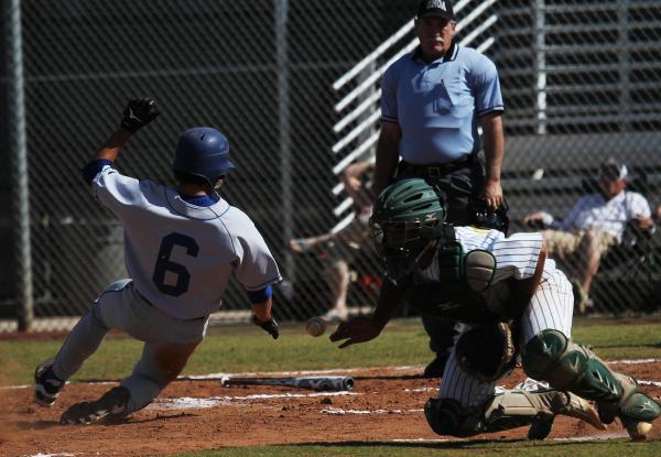 Sierra Vista’s Cole Crosby slides home as Rancho catcher Chris Fitzpatrick tries to co ...